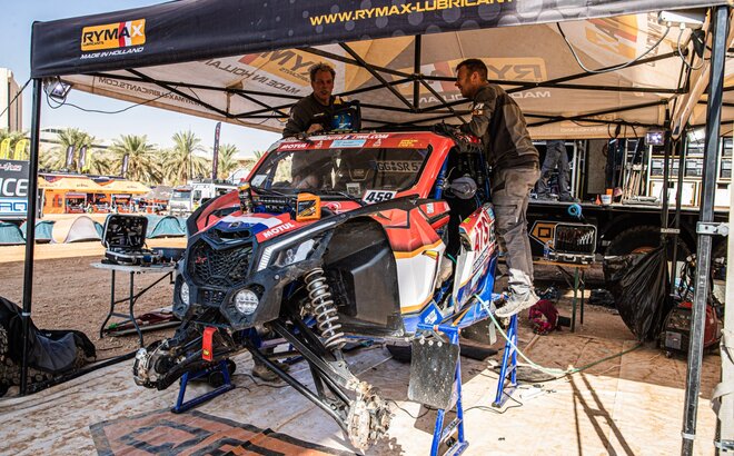 The race tent is located at the Dakar Rally 2022 and protects Rymax car and  mechanics from the sun
