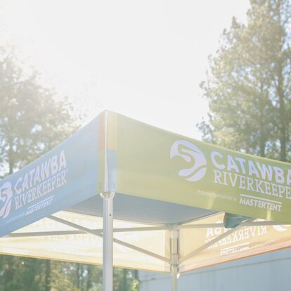 A custom 5x5 tent with printed graphics created for Catawba Riverkeeper. 