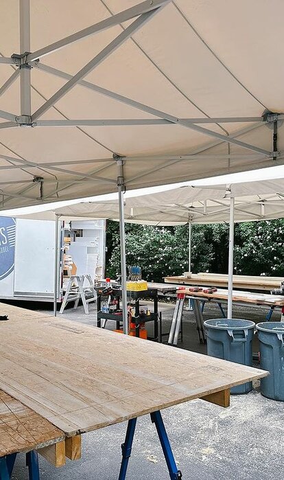 Carpenter working under Mastertent canopy on a job site