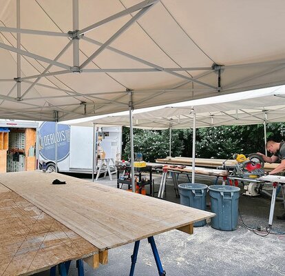 Carpenter working under Mastertent canopy on a job site