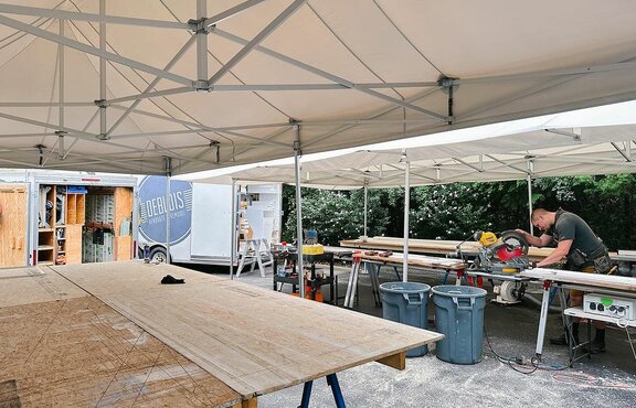 Carpenter working under Mastertent canopy on a job site