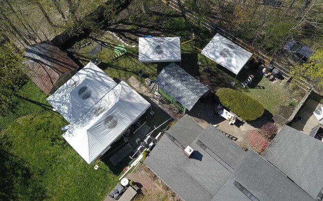 Bird's eye view of DeBlois Renovate and Remodel work site, with four Mastertents set up. 