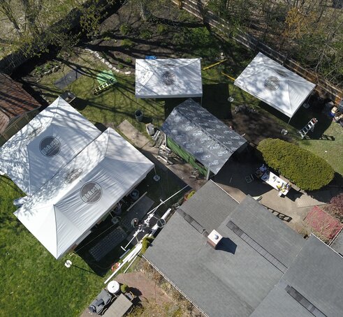 Bird's eye view of DeBlois Renovate and Remodel work site, with four Mastertents set up. 