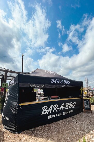 A black, 15x10 Mastertent canopy tent with wrap-around walls and serving counter. Branded for Bar-A-BBQ barbecue company.