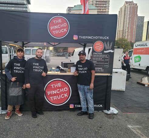 A custom 10x10 food service tent with a wood counter and half sidewalls. 