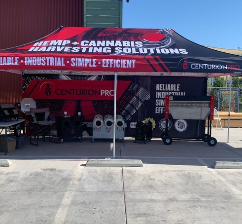 A 20x10 tent shading industrial equipment with custom printing, sidewalls and base weights.