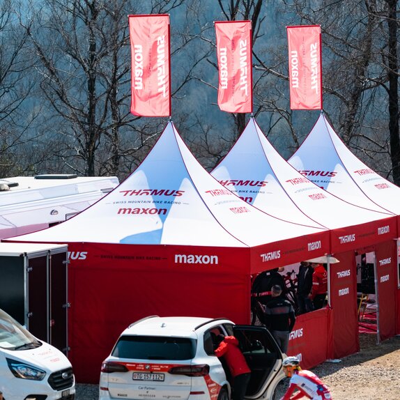 3 custom 17x17 mountain biking team tents with peak flags and custom sidewalls.   