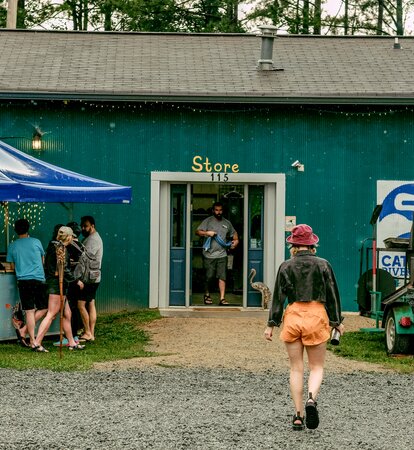 Crowd taking shelter from the rain under a Catawba Riverkeeper branded pavilion. 
