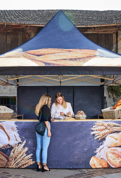 A 4-Awning Mastertent Canopy Tent designed to sell bread at a market.