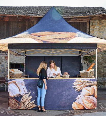 A 4-Awning Mastertent Canopy Tent designed to sell bread at a market.