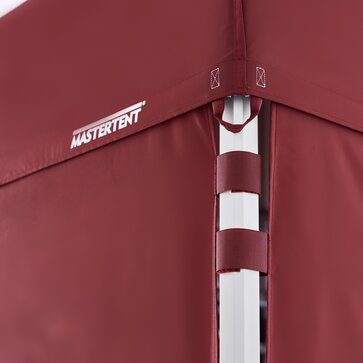 Corner pole of a canopy tent with burgundy roof and burgundy fabric walls attached to pole with two velcro straps 