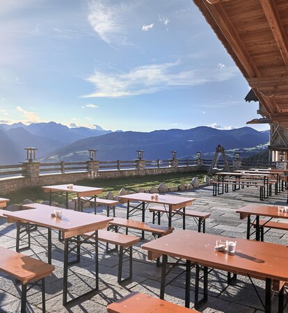 Mastertent beer table sets on an outdoor dining patio near a mountain range.