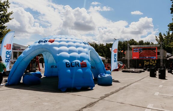 Large blue inflatable shelter at concert venue. 
