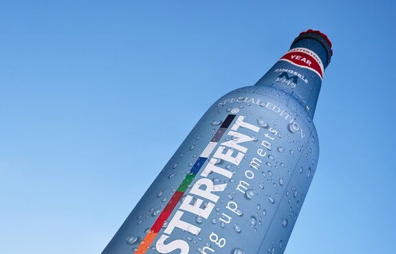 Mastertent branded bottle inflatable backlit on a field