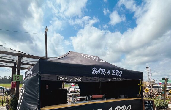 A black, 15x10 Mastertent canopy tent with wrap-around walls and serving counter. Branded for Bar-A-BBQ barbecue company.