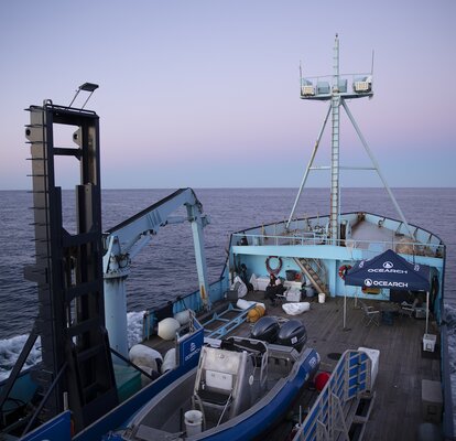 A Mastertent canopy tent on the deck of a large Ocearch company boat going out to sea.