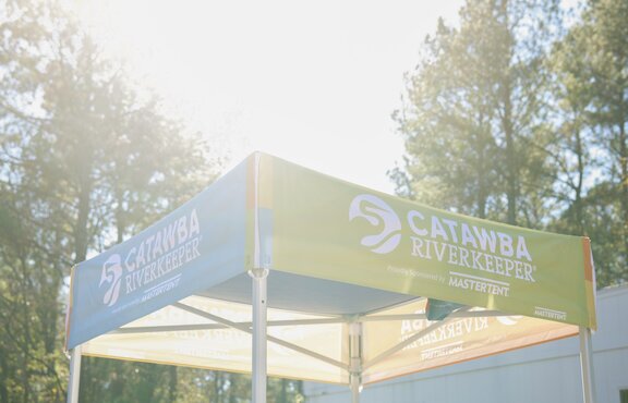 A 5x5 Mastertent nonprofit tent roof with custom printing designed for volunteer events and outreach. 