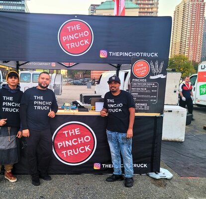 A custom 10x10 food service tent with a wood counter and half sidewalls. 