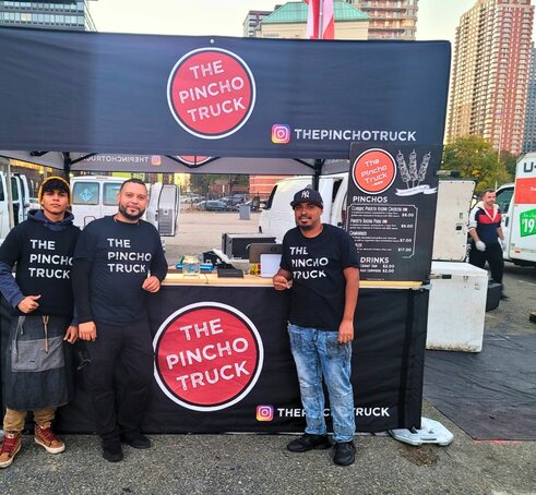 A custom 10x10 food service tent with a wood counter and half sidewalls. 