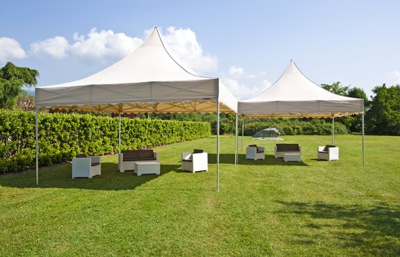 A 17x17 large event tents in Ecru for weddings and parties. Customized with a scalloped roof. 