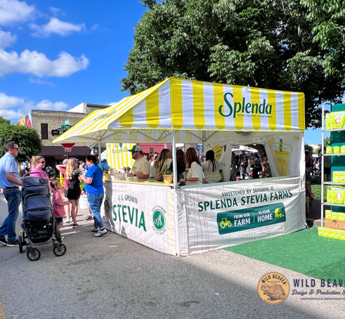 A 10x10 custom tent for a beverage company serves at an event.