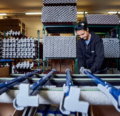 A woman is working at the production of tents. 