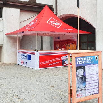 The fully personalised promotion tent of the Euregio Family Pass is located in front of a wall