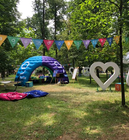 An inflatable tent is located at the Jazz in the Park Festival. It is colourful and big. It serves as a chill lounge and promotion corner. 