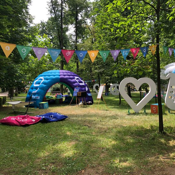 An inflatable tent is located at the Jazz in the Park Festival. It is colourful and big. It serves as a chill lounge and promotion corner. 