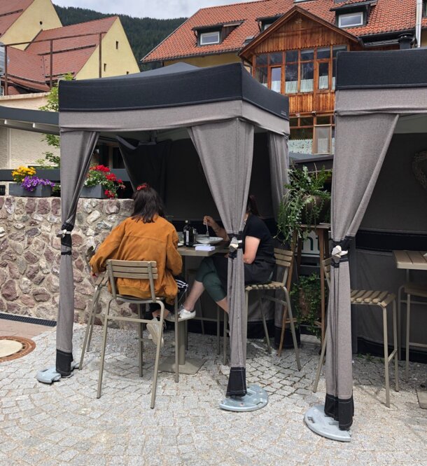 Two gazebos with loden cover in use as gastronomy tents.
