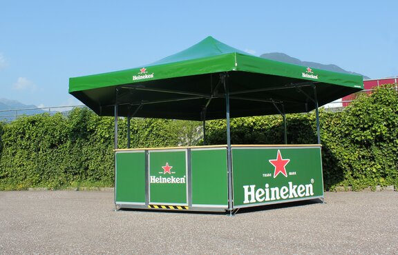 Green hexagon pavilion for Heineken. The beer pavilion is located on a square. 