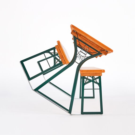 The table and the left bench of the beer table set are inclined. They are leaning on the right bench of the set.