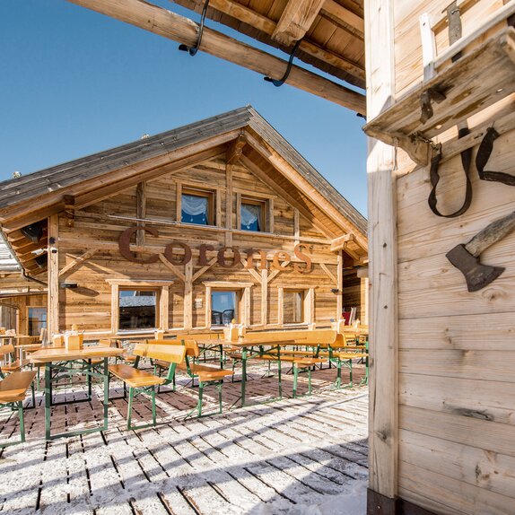 Numerous Dolomit beer tent sets with the weather-resistant surface treatment in front of the mountain hut Corones Hütte at Plan de Corones at 2,275m. 