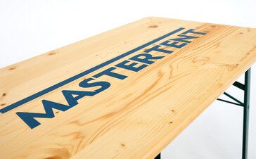 Detailed view of a beer tent treated with the screen printing technique. The MASTERTENT logo is printed on the beer table. 