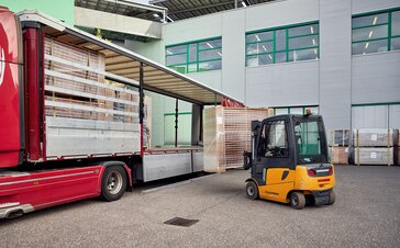 The beer tent sets are transported on a truck in transport containers.  