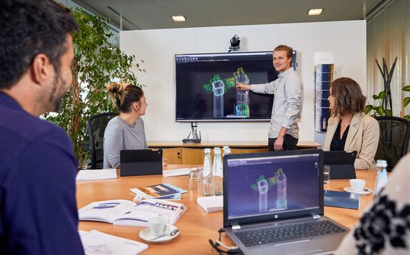 Employees are sitting in a meeting where they are discussing the latest innovations.