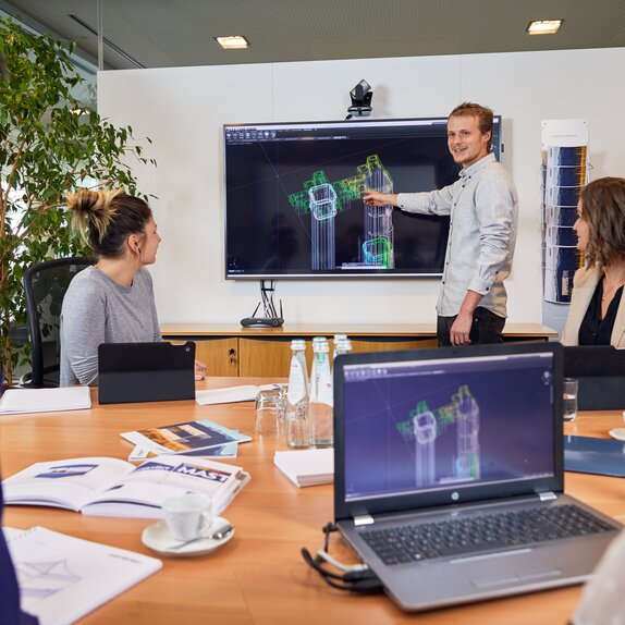 Employees are sitting in a meeting where they are discussing the latest innovations.