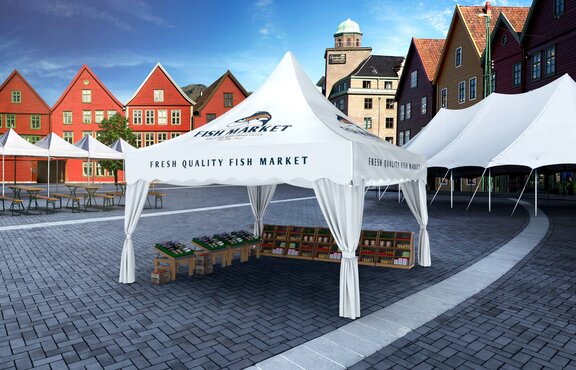 The white pagoda tent is located on the market square. Underneath the gazebo some boxes with fish from the sea are situated. In the background are some red buildings. 
