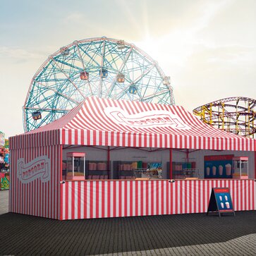 Red-white striped gazebo at a fun fair or carnival. The gazebo is printed with the incription "Popcorn". It serves as a popcorn stand. 