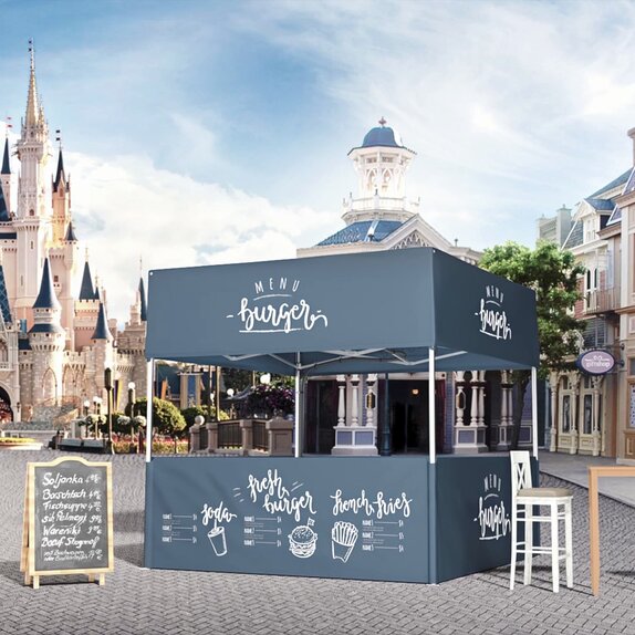 Blue gazebo with flat roof serving as a burger stand on a square. In the background of the picture a church can be seen. 