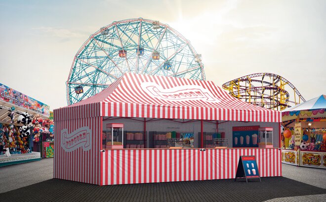 Rot-weiß gestreifter Faltpavillon auf einem Jahrmarkt oder Rummel. Der Faltpavillon ist mit der Aufschrift "Popcorn" bedruckt und dient als Popcornstand.
