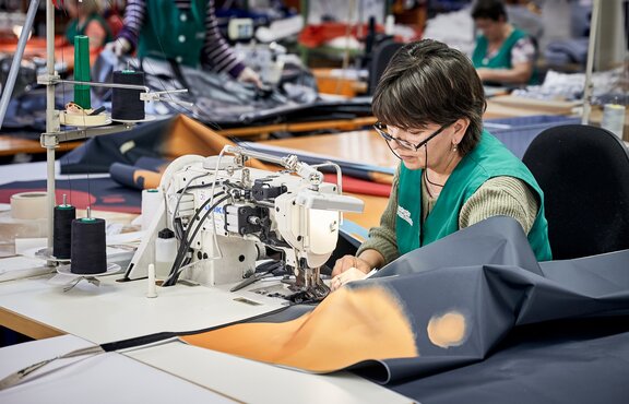 The folding pavilions are sewn together in the sewing room.