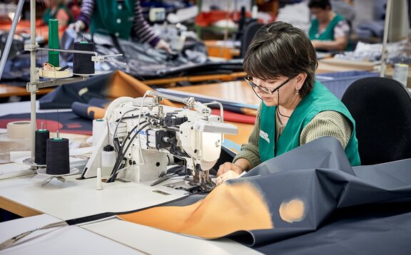 The folding pavilions are sewn together in the sewing room.