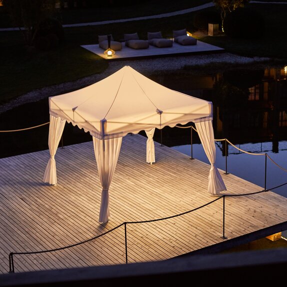 Gazebo with lighting from Mastertent at a footbridge by night 