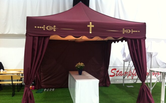 A bordeaux red folding tent for funerals.