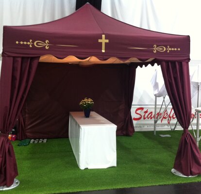 A bordeaux red folding tent for funerals.