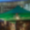 A green gazebo from Heineken is located in front of the stage. It is used as a beverage stand at the event. 