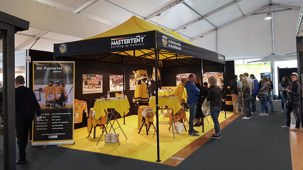 Gazebo 6x3 for trade fair. Yellow and black gazebo customised with HC Pustertal team logo.  