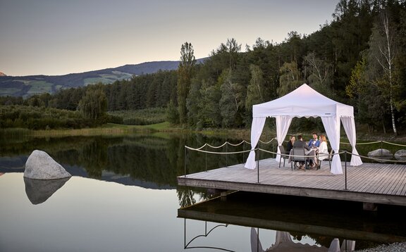 An elegant canopy tent set up for outdoor dining.