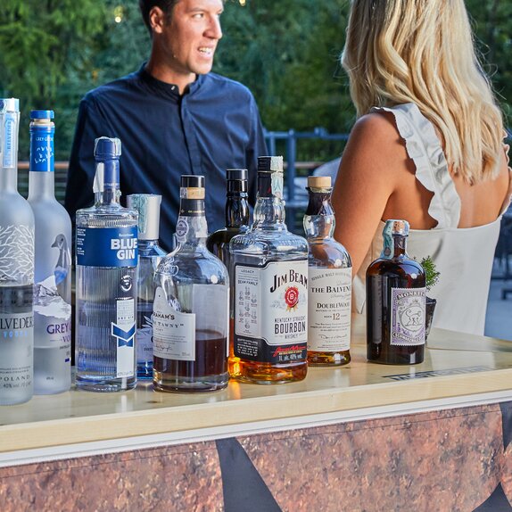 Various drinks are available at the counter of the beverage stand.